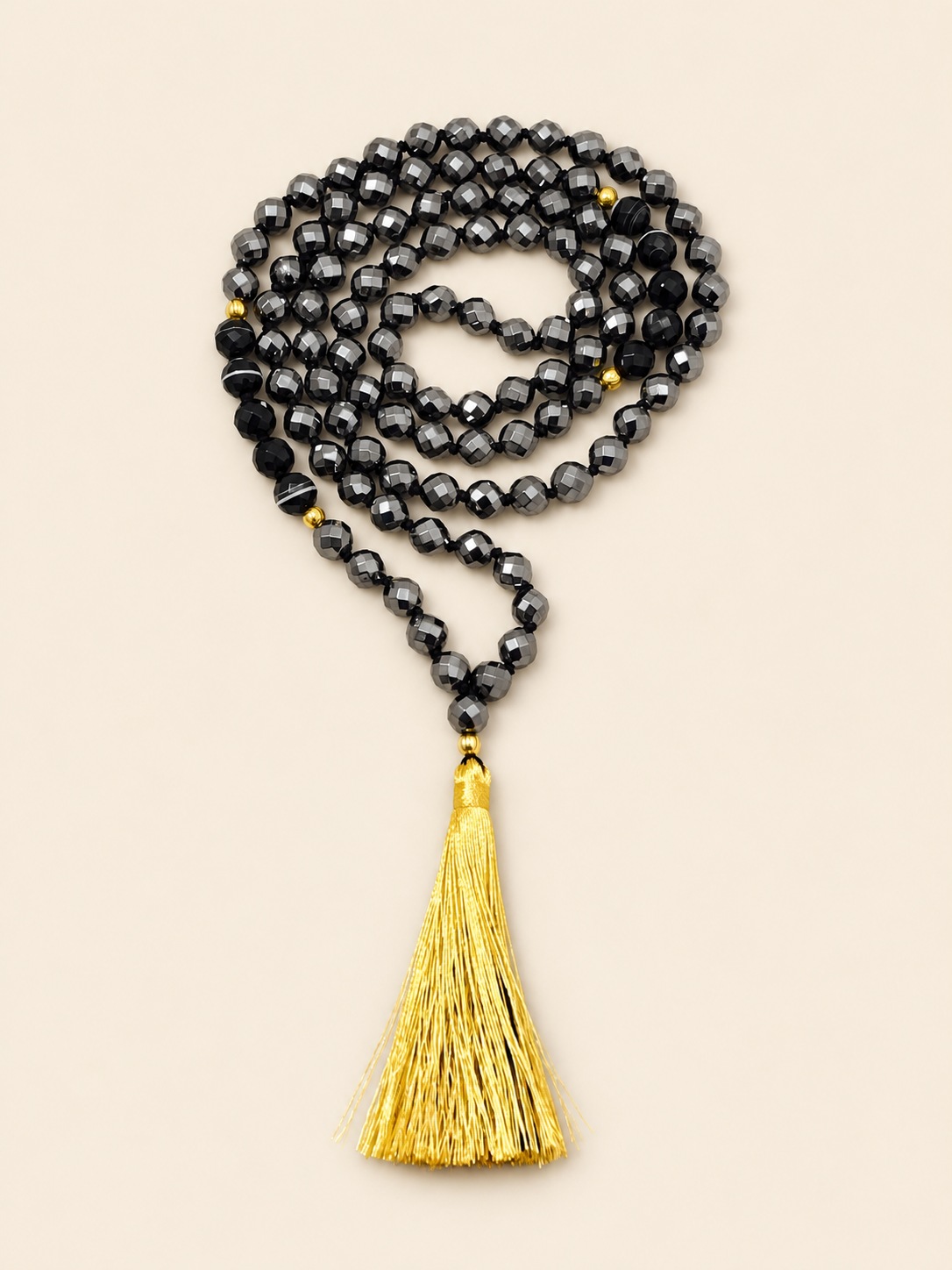 Original Yantrakart dark faceted mala with a golden tassel